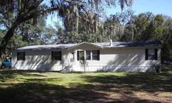 Price has been reduced AGAIN on this wonderfully spacious 4 bedroom/2.5 bath double-wide mobile home with its 2,280 square feet of living space is located just west of Zephyrhills, Florida on a 1 acre lot on paved Allen Road. The home sets behind a large