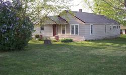 Upgraded 3 bedroom 2 bath home with sunroom, new central heat/air, fireplace, utility room, hardwood floors, sitting on pretty acre+ with room for garden, calf. There are many outbuildings, barn, 2 car garage. No mobile homes allowed. Very pretty place,