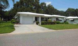 Located in the 55+ Tamarac by the Gulf community, this two bedroom, two bath home has a lovely golf course view and is located on a corner lot. There is a Florida room with approximately 170 square feet that is not included in the square footage of the