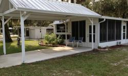 GREAT AND AFFORDABLE GET AWAY OR FULL TIME LIVING! CLEAN, TURN-KEY MOVE IN w/plenty of parking under a Gabled Carport Lot 61E www.HolidayTravelResort.com all age Park.Trailer has tub shower, oven, cook top, microwave, ac new flooring, new upholstery, new