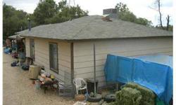 Three bedroom two bath home on five acres plus a three bedroom two bath double wide mobile home. Both homes need some TLC but are rented for at total of $1800 per month. Kitchen and bathrooms were remodelled six or seven years ago. Mobile home is quite