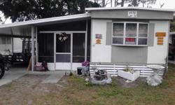 1980 14x55 mobile home with 2 beds and 1 bath located in the main part of the house and a 3rd bedroom with small Florida room located at the base of the house about 14x30. The house also features a carport with a workshop, an inside storage room and a