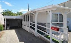 Nice well kept mobile home in park. 2 bedrooms, 1.5 baths. Kitchen appliances stay. New carpet thoughout the home. Carport space with small workshop area. Listing agent is the owner of this property.Listing originally posted at http