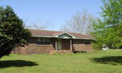 A beautiful 4+ acres with grape arbors, fruit trees and pecan trees is the country setting for this brick home. Living room with fireplace, large dining room and kitchen with eat/work bar. Double attached garage and metal barn. DIRECTIONS