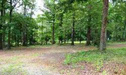 Country setting. Beautiful 1 acre corner lot with hardwoods. Underground utilities. Septic system in place. Seller to have septic pumped and water tap installed before closing. Mobile home had previously been on lot so very little site preparation needed.
