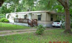 Furnished winter home!! Just bring your tooth brush. Fenced front yard, lots of trees for shade. New kitchen cabinets in 2005. Split bedroom plan. Relax on the screen lanai and watch the squirrels play. Carport plus shed. Investors--this would make an