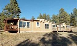 Sit back and enjoy the views from either of the two decks on this well laid out modular home. Living room walks out to the South deck with views of trees, rock formation and the mountains. Family room with free standing stove walks out to the West deck,
