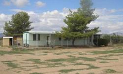 Large and level 1.28 acre parcel of fenced land with bonus "as-is" singlewide manufactured home. Home needs some work. Septic inspection already completed. Call us now for your personal tour!Wesley Hassell has this 2 bedrooms / 1 bathroom property