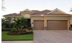 Step into this warm and inviting home in pristine condition. Located in a guard-gated golf community, this home is surrounded by lush, beautiful Florida landscape. Enter into an inviting foyer that captures your eye to the spacious living space and view o