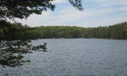 Lakefront wooded lot with water view. Offering 100 ft. of frontage, property qualifies for Type A Dock Permit. Well for property on adjacent property. Listing agent and office