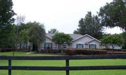 Gorgeous 4/2 with oversized 2 car garage, split BR pool home w/2613 SFLA. Gated (electronic)entrance and fully fenced, beautiful 2.5 acres. Bring your horse! Country living yet right in town and close to everything. Very private home located at the end of