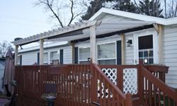 This is a very nice 1997 Homark Royal American manufactured home.The huge living room, Jacuzzi tub, french doors and large deck make this a great next home!Living room