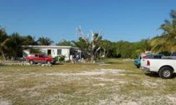Amazing location with multiple development possibilities. 2 lots, nearly 1 acre of land with 120.92' of Overseas Highway frontage and 132' of Water frontage. Property is zoned residential, multi-family less than 10 units. Largest lot has a duplex, each