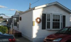 Comfortable, year round or second home living in this lovely mobile home located in sought after location close to bird sanctuary, beaches and Sachuest Point Park. Living room open to dining area and kitchen with many cabinets. Bedrooms are at either end