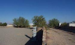 Nice lot in Rainbow Acres. Has Mexican Block walls with wrought iron gates. Two Full RV Hookups with 50 amp service. Lot has a wash next to it for a little more space between you and the neighbor. Area is popular with the desert enthusiast.Listing