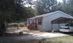 This is a well kept 2005 mobile home. It has 3 bedrooms and two bathrooms. There is a carport included with pavement leading to the front door.The home sits on 3 large lots which serves for a big yard. It is also near Wal-Mart and Silver Springs