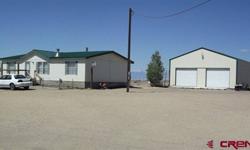 This well kept manufactured home sits on 1.25 acres with beautiful views of Mt. Blanca and plenty of peace & quiet just minutes from town. There is a 30 X 40 metal shop that gives you ample room for parking and storage and the home has a wood burning