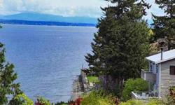 Ultimate downtown Langley Waterfront hideaway privately tucked on a 60' medium-bank is designed to capture the panoramic water Saratoga Passage and Cascade mountain views with decks, balconies, terraces & stairs to the bulkhead landing & beach. Keep your